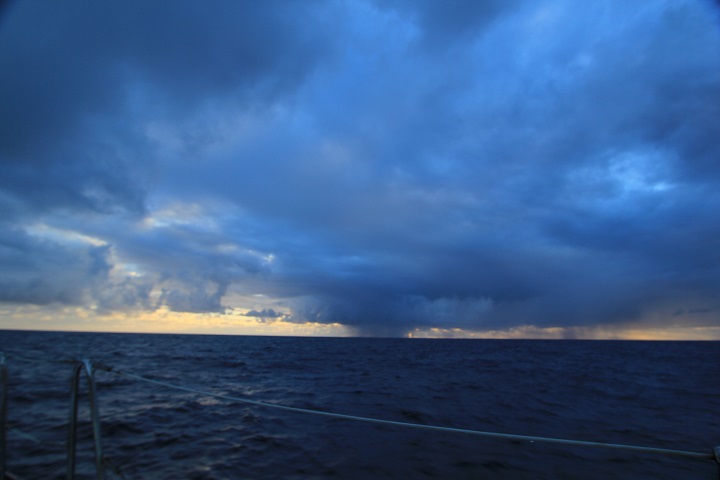 ocean sunrise over a stormy sky